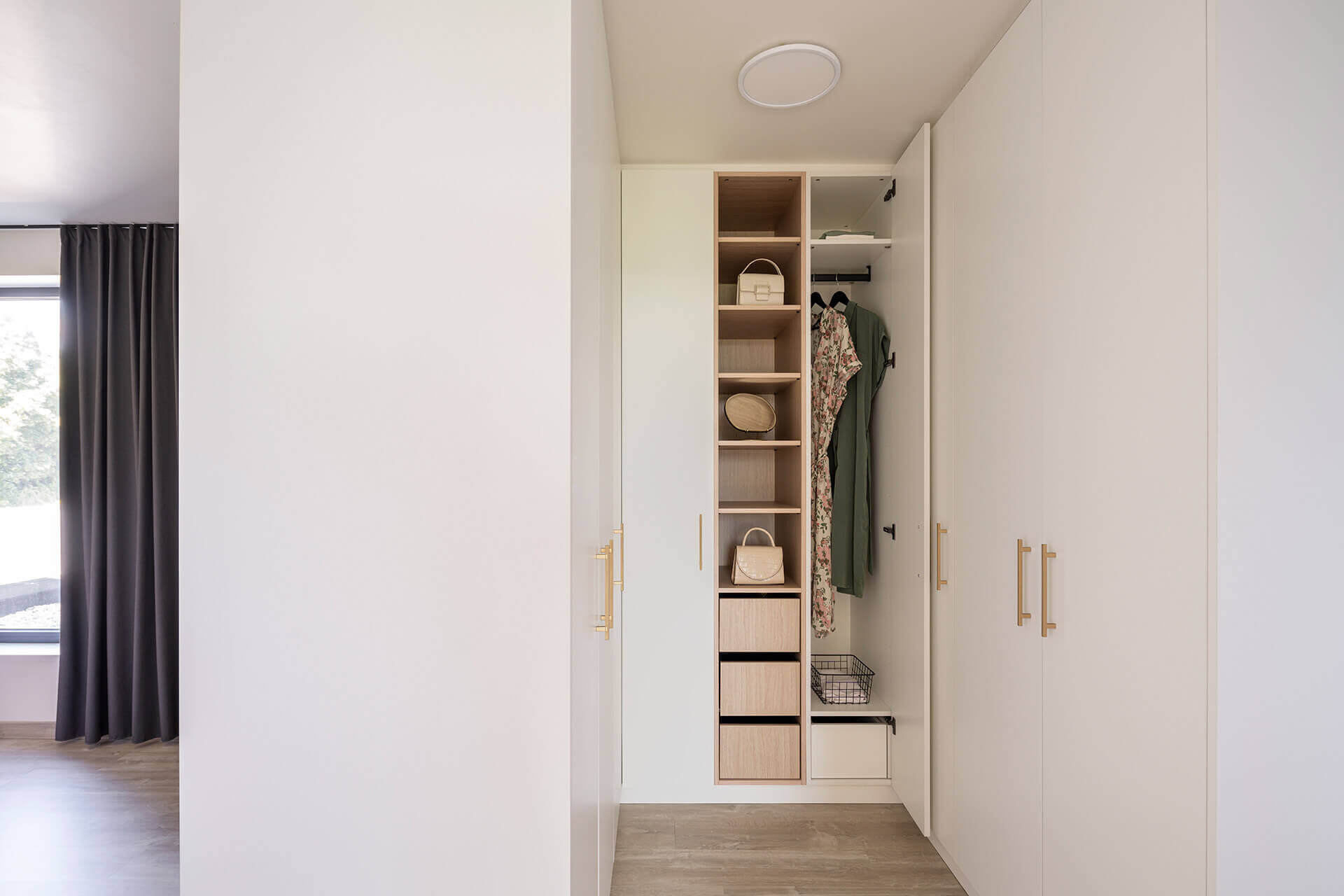 Dressing en U sur mesure dans la chambre en Front White et Atlas Oak avec poignées Diamond en laiton
