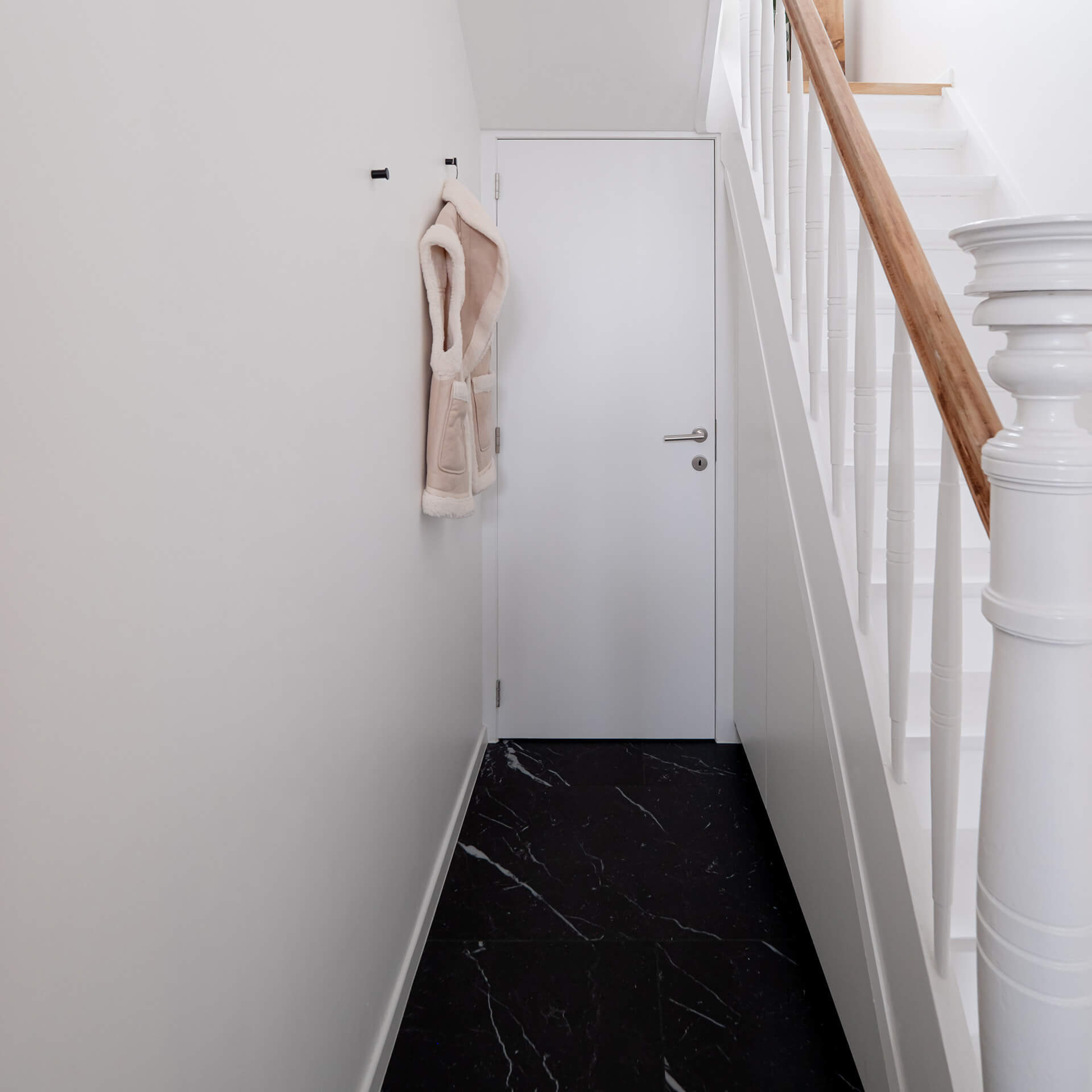 Hall avec une armoire sous escalier sur mesure blanche