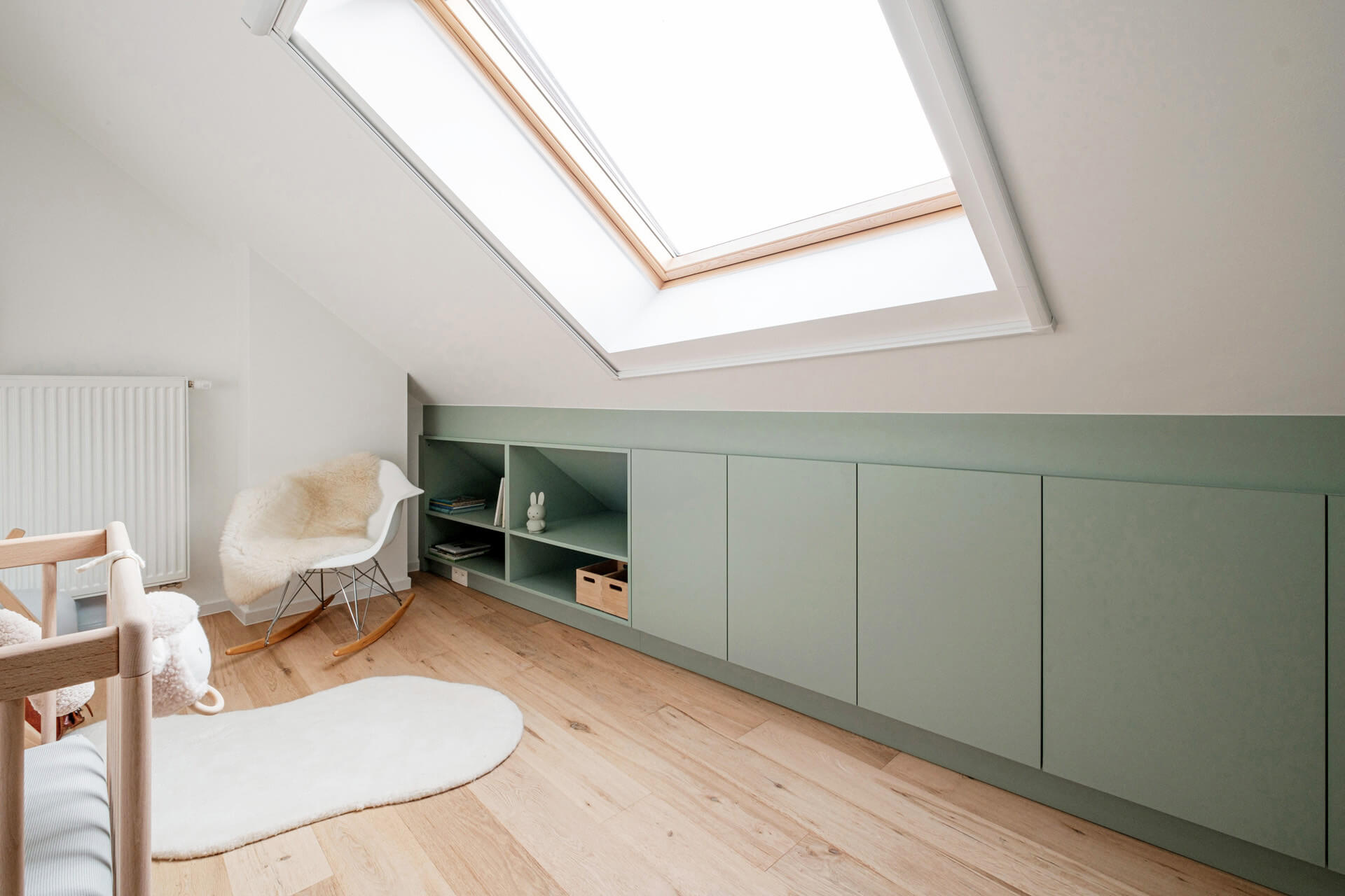 Meuble sous pente en vert dans la chambre d'enfant.